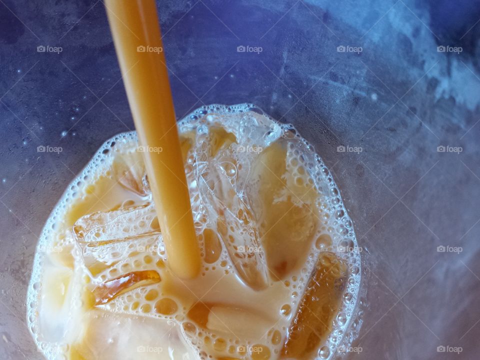 Tasty. A view into the refreshing, tasty glass of Thai iced tea.