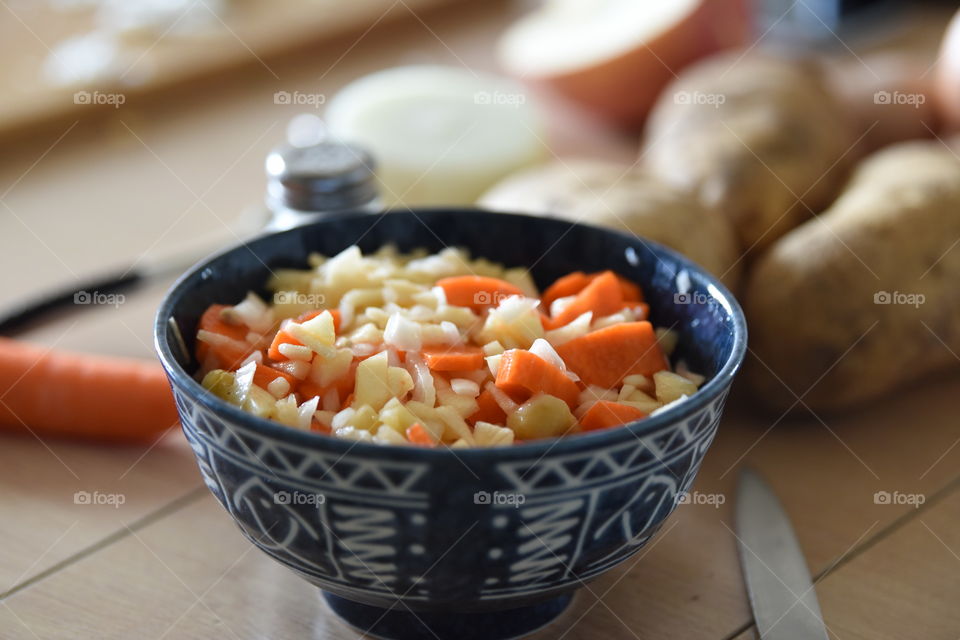 Carrot salad apple and onions nice bowle potatos knife in the background