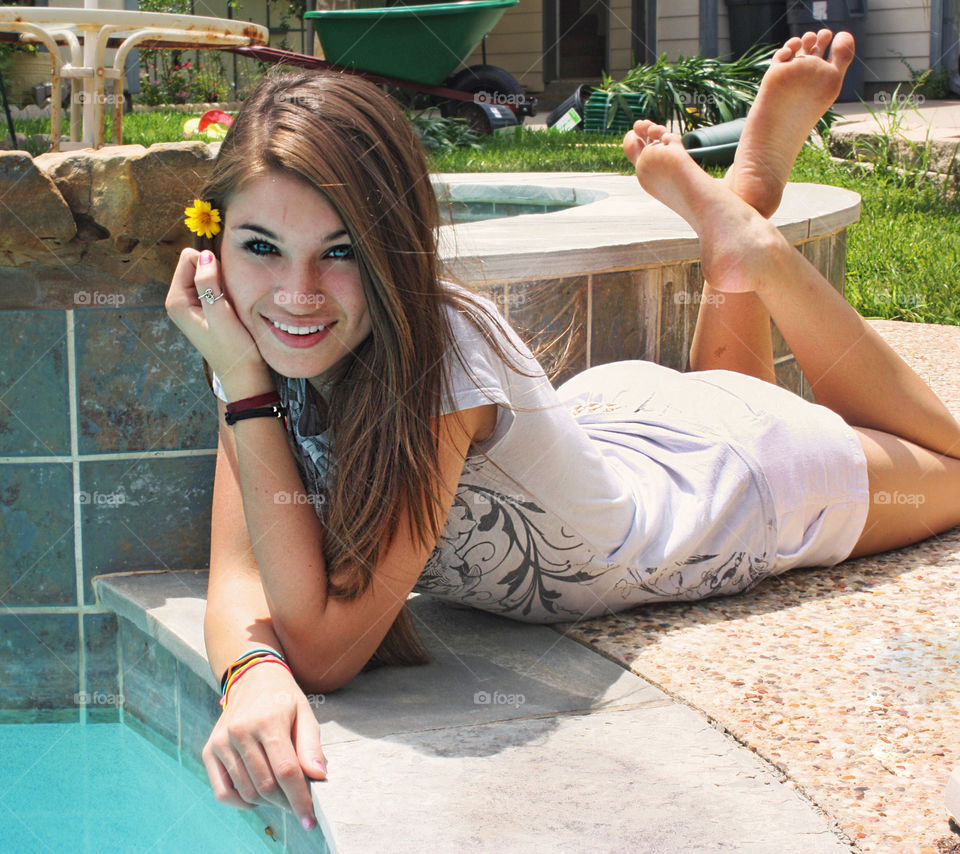 Pretty woman lying at pool side