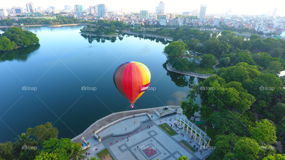 High angle view of multi colored air balloon and idyllic lake