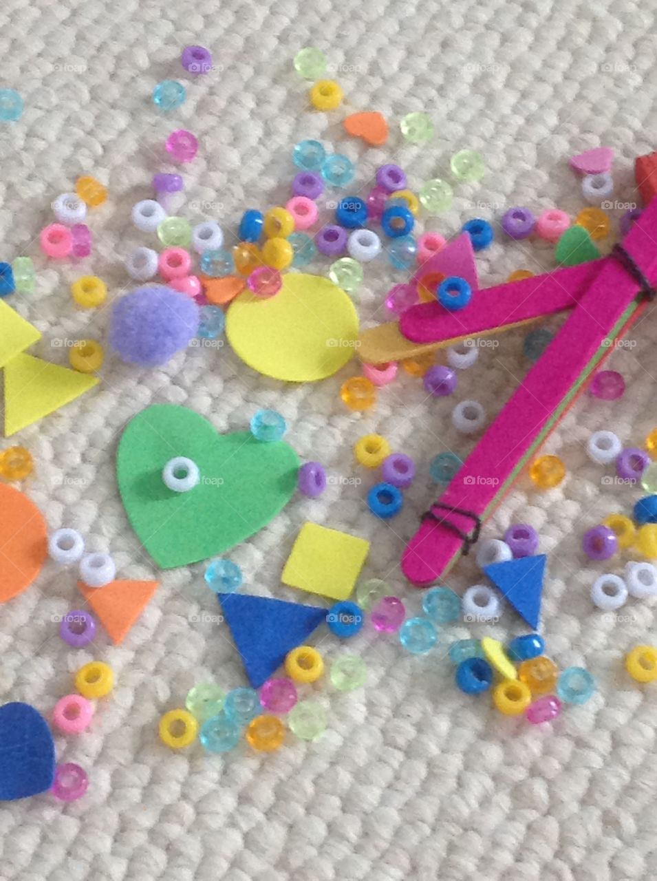 Colorful beads, popcicle sticks and different shape stickers for arts and crafts supplies. 