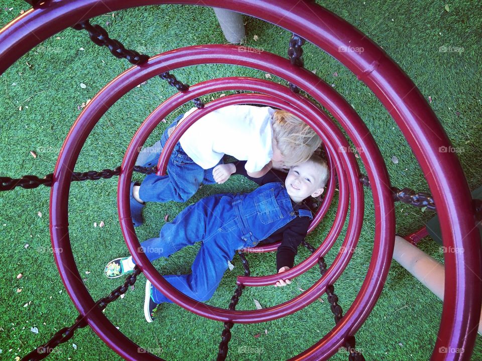 Boys playing on jungle gym at playground