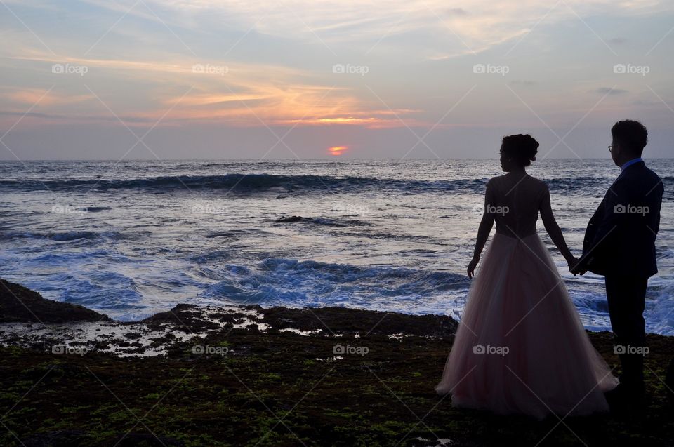 Sunset. A newly wed couple looks at the beautiful sunset