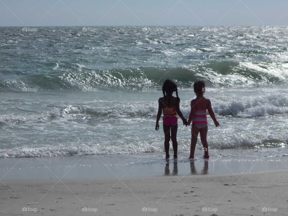 Friendship. My daughter & her cousin braving the waves.