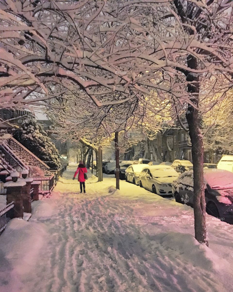 In the streets of Montreal, during a magical winter night. A lady in red passing by.