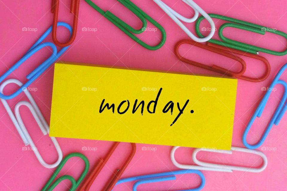 Paper clip and sticky notes reminder for monday file...