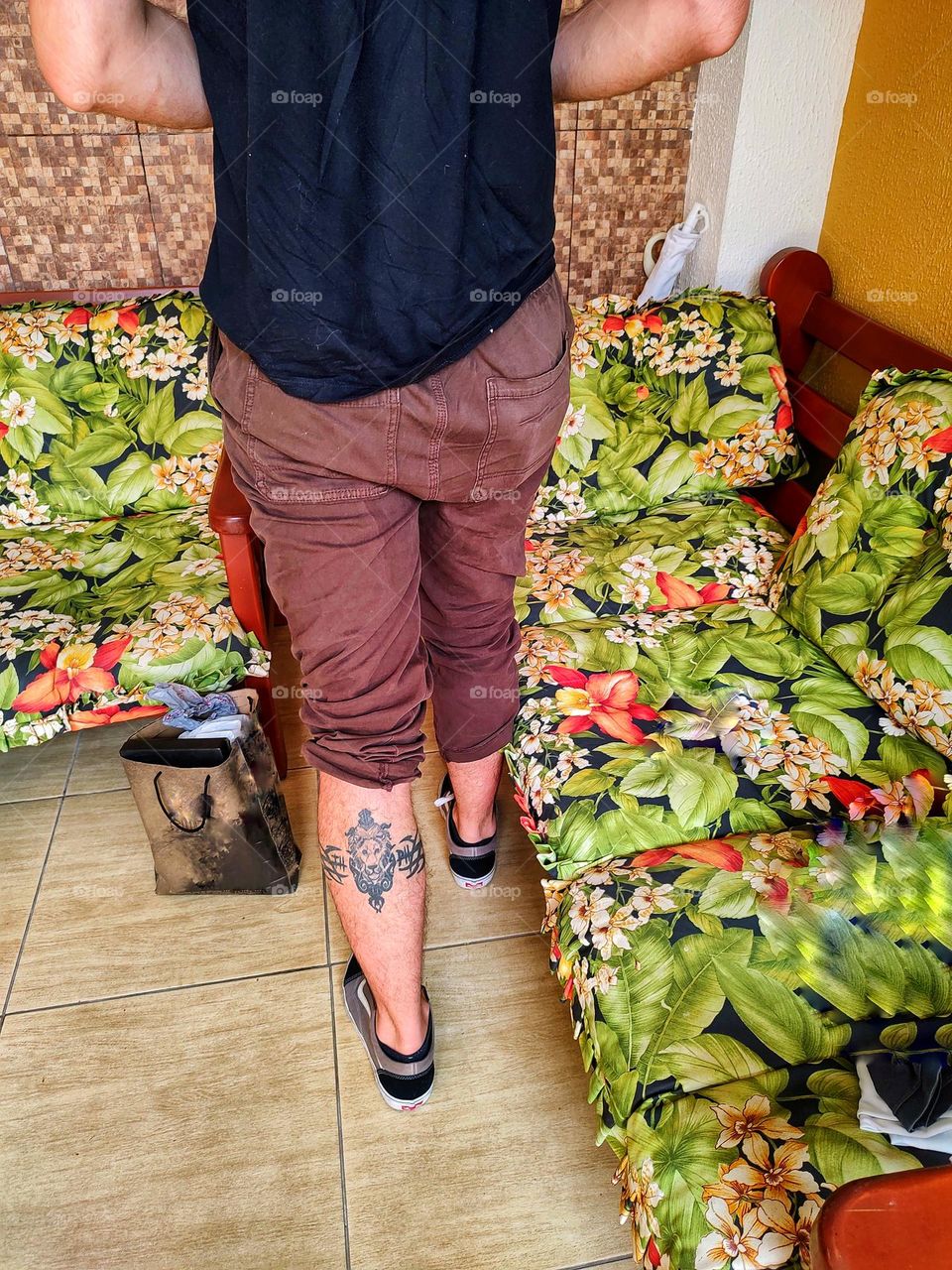 boy with a tattoo on his calf.