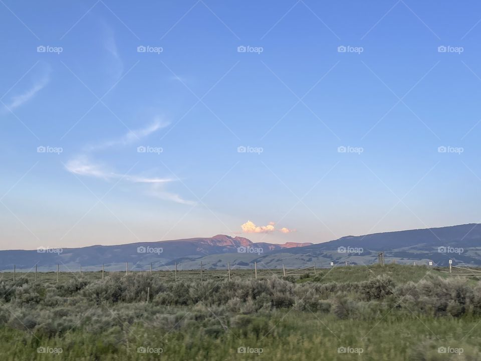 Sunsetting sunset Mountain and Field and Prairie beautiful blue skies sky cloud clouds