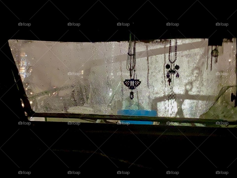 This is the night view from “Salvation”, our “28 ft 1969 Luhrs” at “Newtown Creek” in LIC. Lights from outside apparently cast shadows on the window and moisture from condensation and raindrops create an appealing allure. 2023. Hypnotic Productions