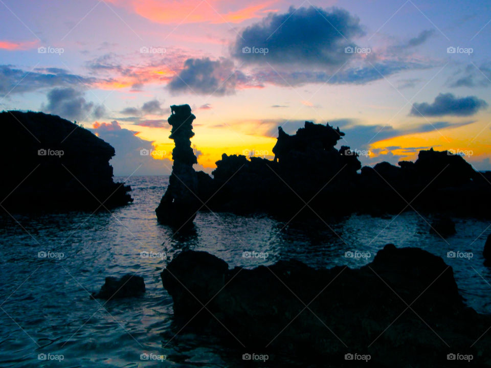 Tobacco bay Bermuda at sunset with the rock formations in silhouette