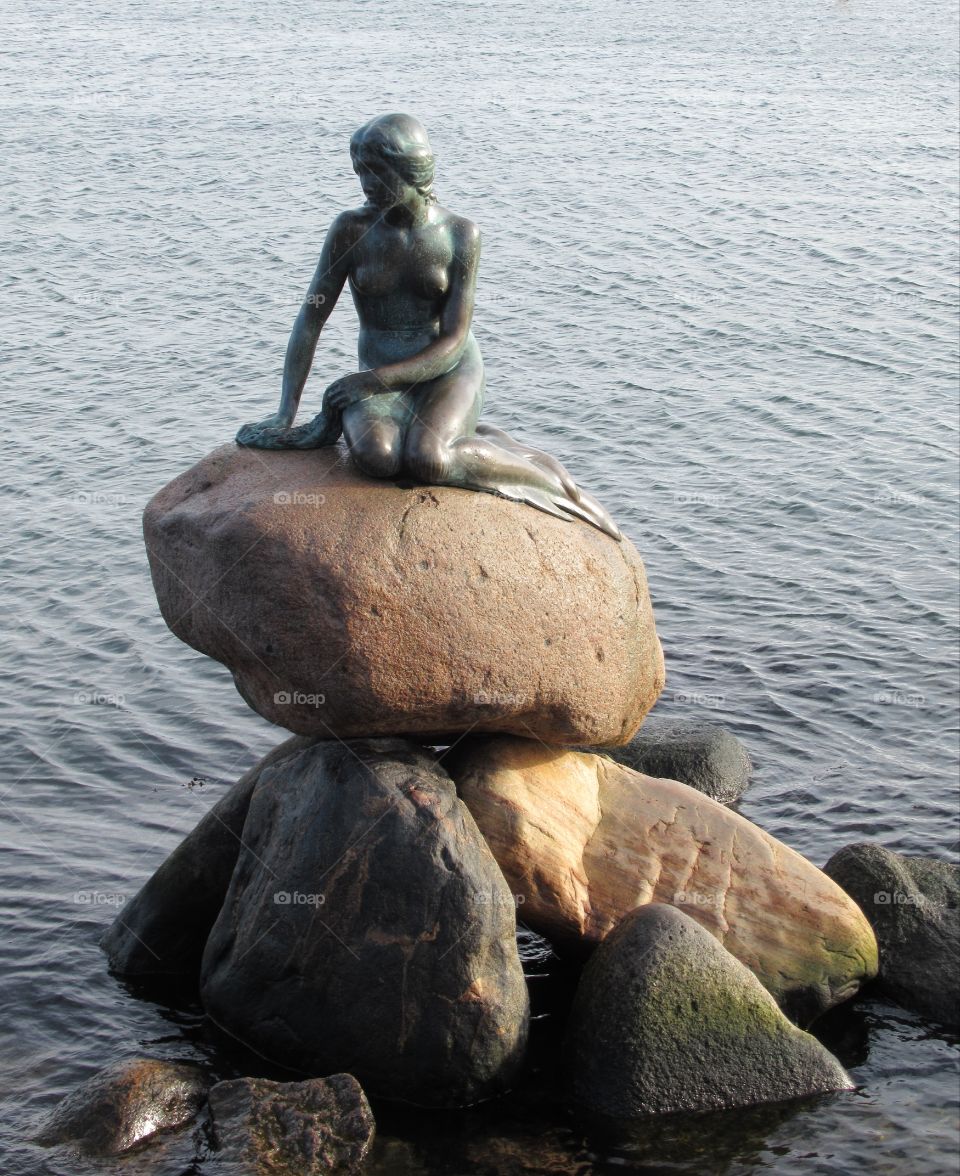 Little mermaid sat on a stone at copenhagen the fairytale written by Hans Christian Andersen