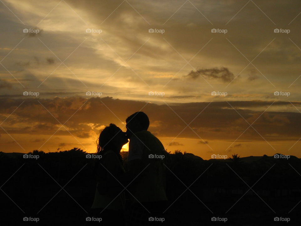Couple kissing in sunset