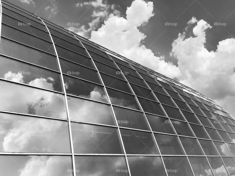 Reflection of cloudy sky in modern city architecture 