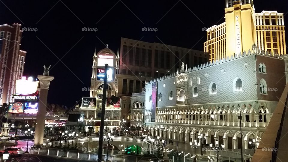 Nighttime Exterior of Las Vegas Strip from the outer walkways of the Venetian. The Palazzo is on the right.