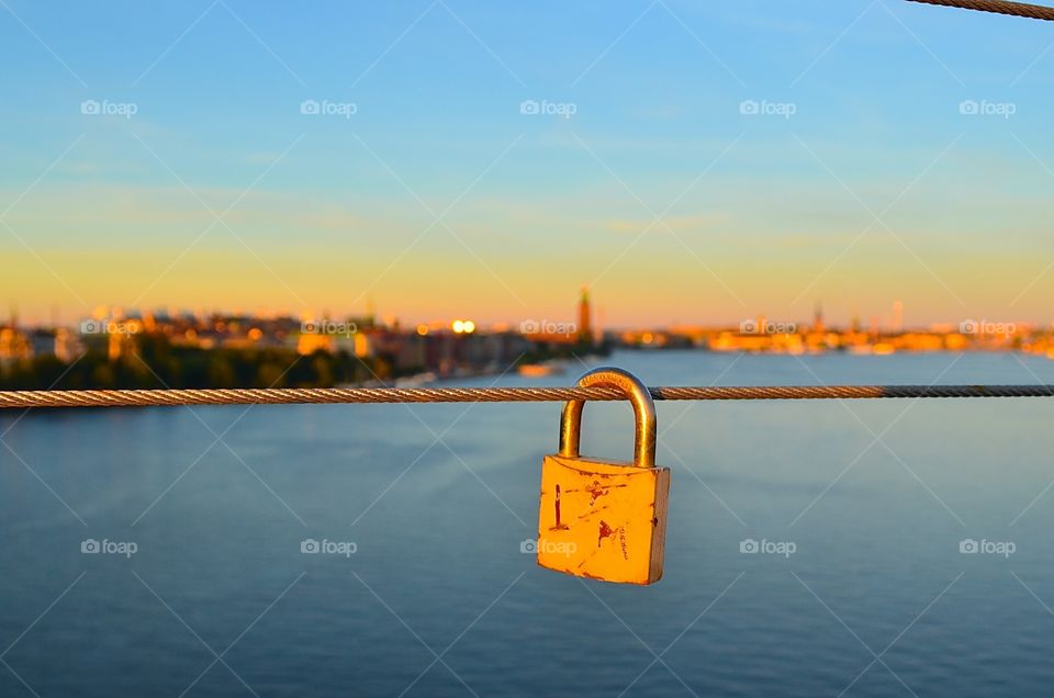 Yellow padlock. Yellow lovelock with a view over Stockholm