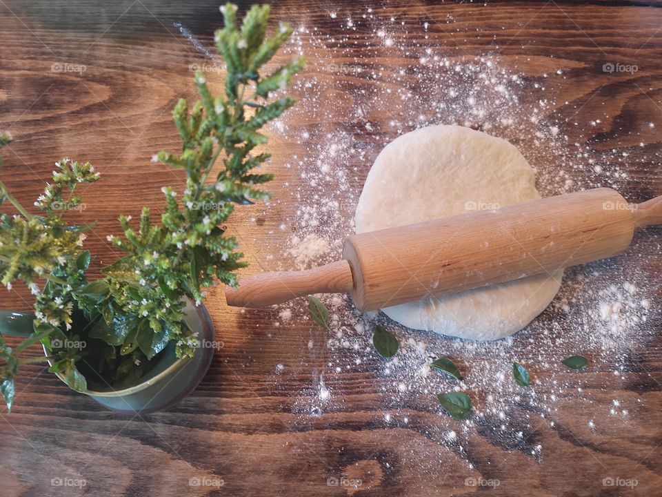 Preparing dough for pizza