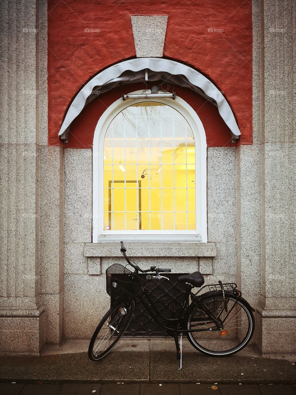 A bicycle under the window.