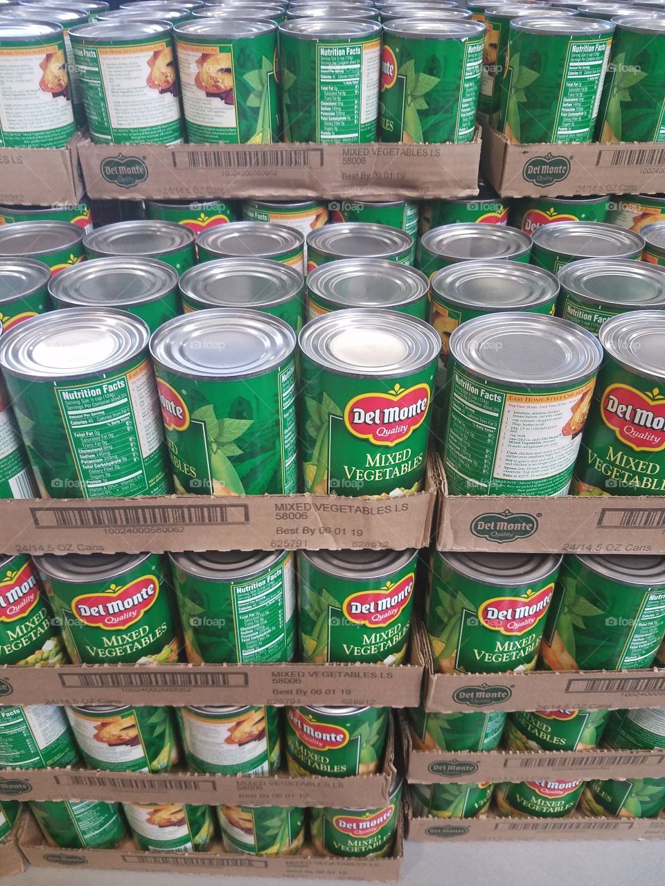 Pallets of green Del Monte mixed vegetable cans