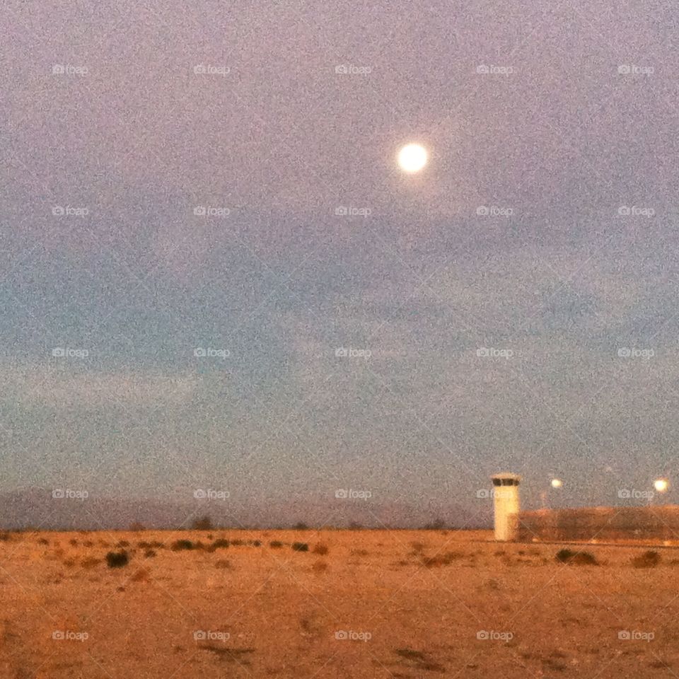 Full moon setting behind prison tower #3. 
