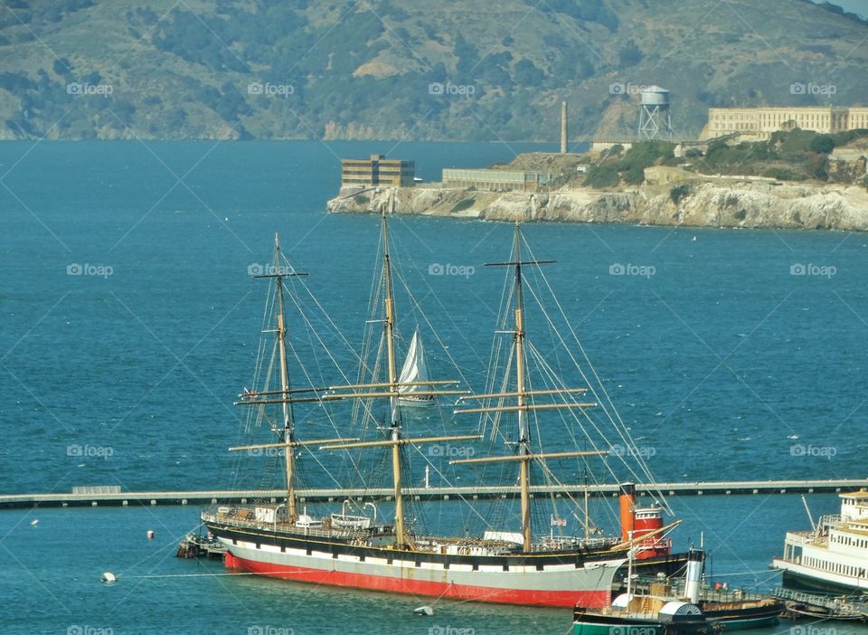 San Francisco Marina. San Francisco Harbor With A Tall Sailing Ship And Alcatraz In Background
