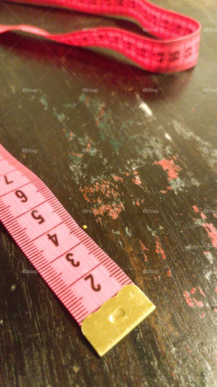 Measuring tape on a wooden table