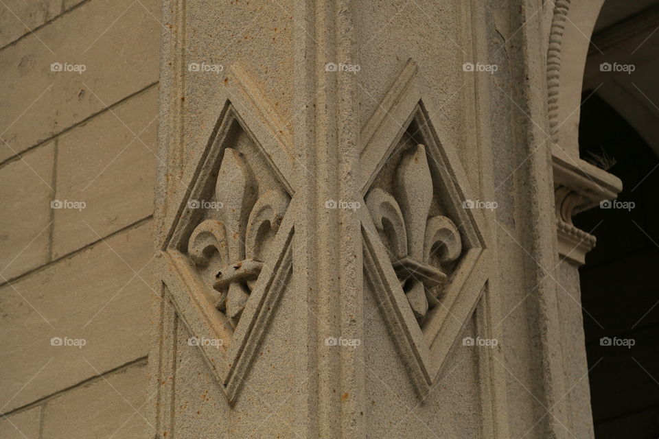 fleur-de-lis carved in stone