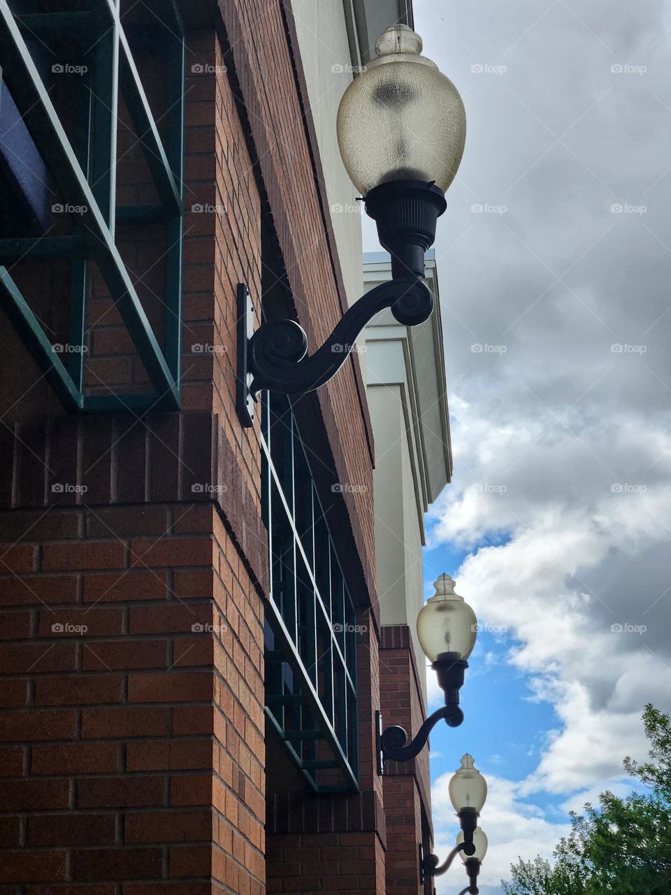 row of outdoor lights on brick building in outdoor Urban shopping center