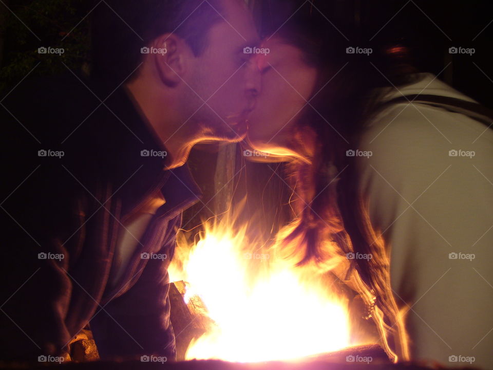Adult couple kissing at night