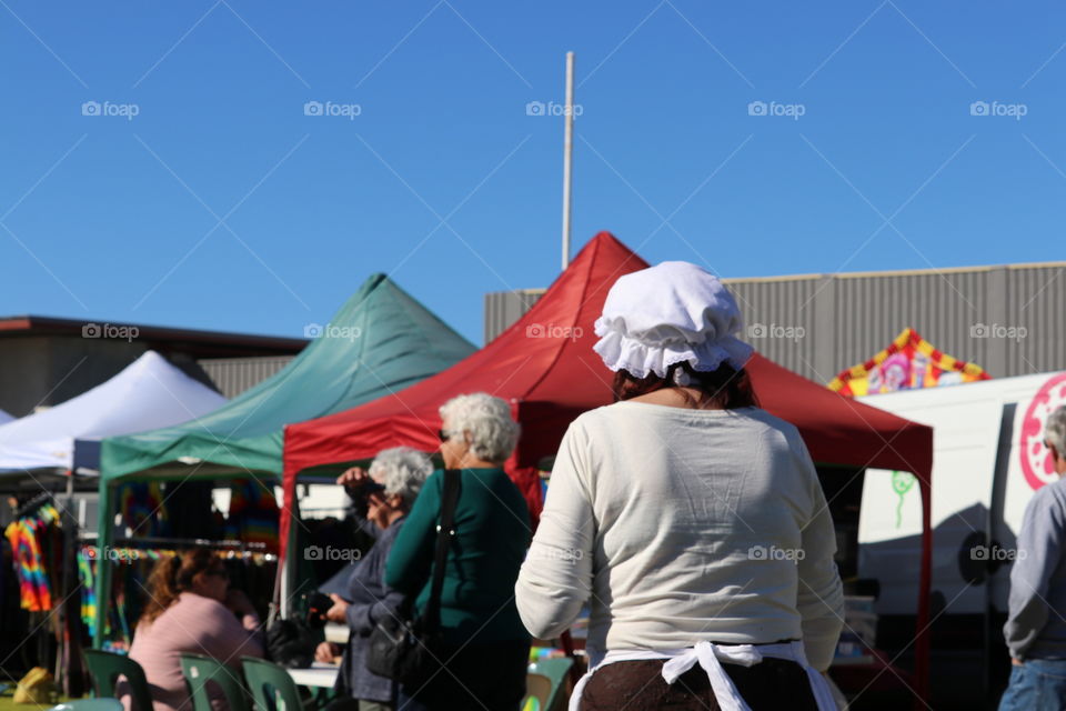 Back view of woman at festival wearing Cornish head dress cap and clothing 