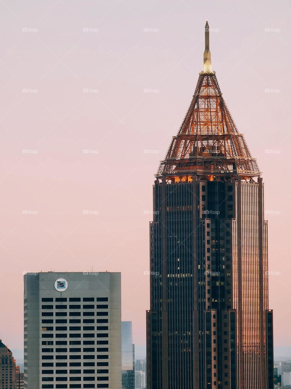 Downtown at sunrise with a pink hued sky casting a warm glow before the hustle and bustle of a busy weekday