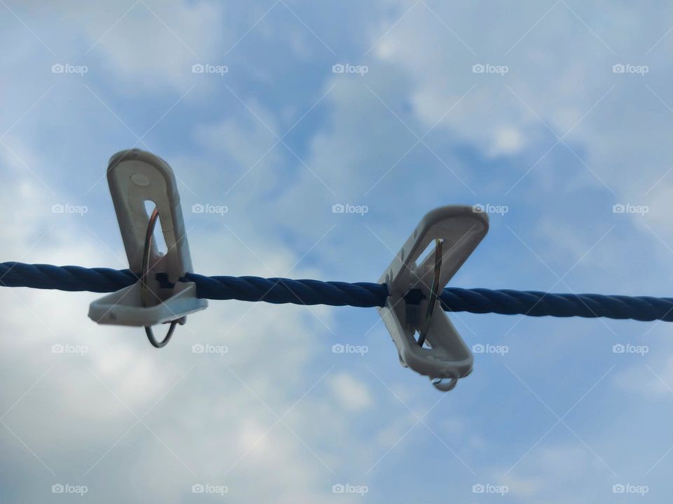 Clothespins, clotheslines against the sky background