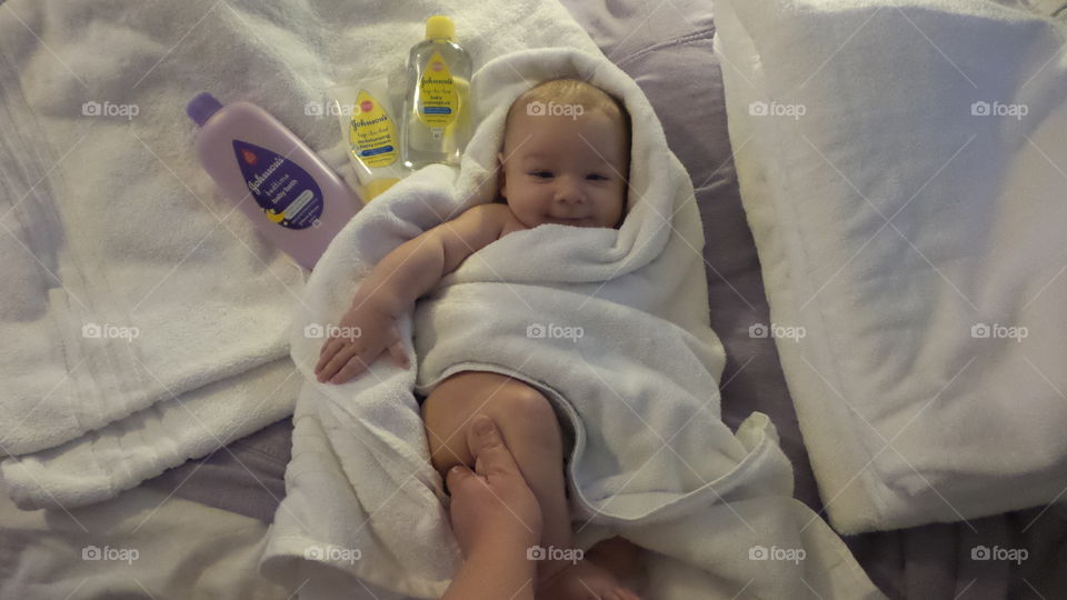 Being pampered with Johnson's products while looking towards the lens. Includes model release