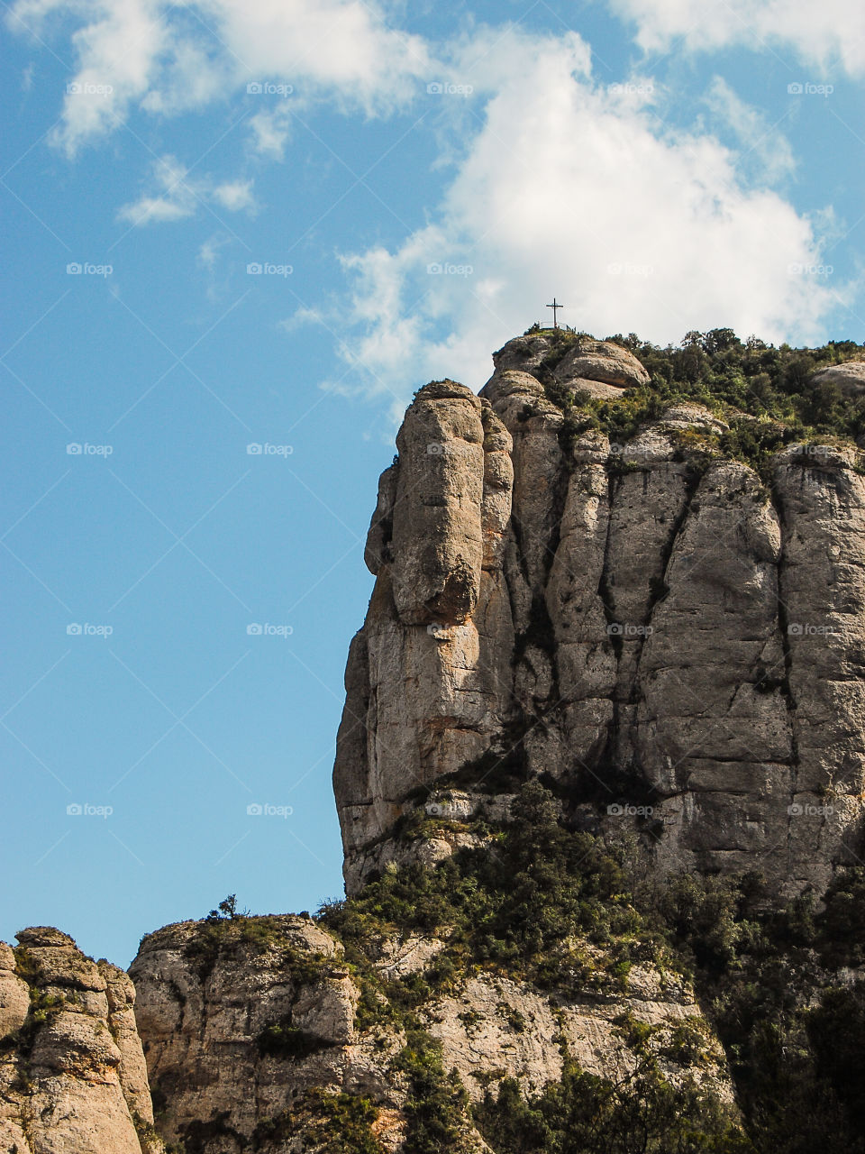 Crucifix over the rocky mountain