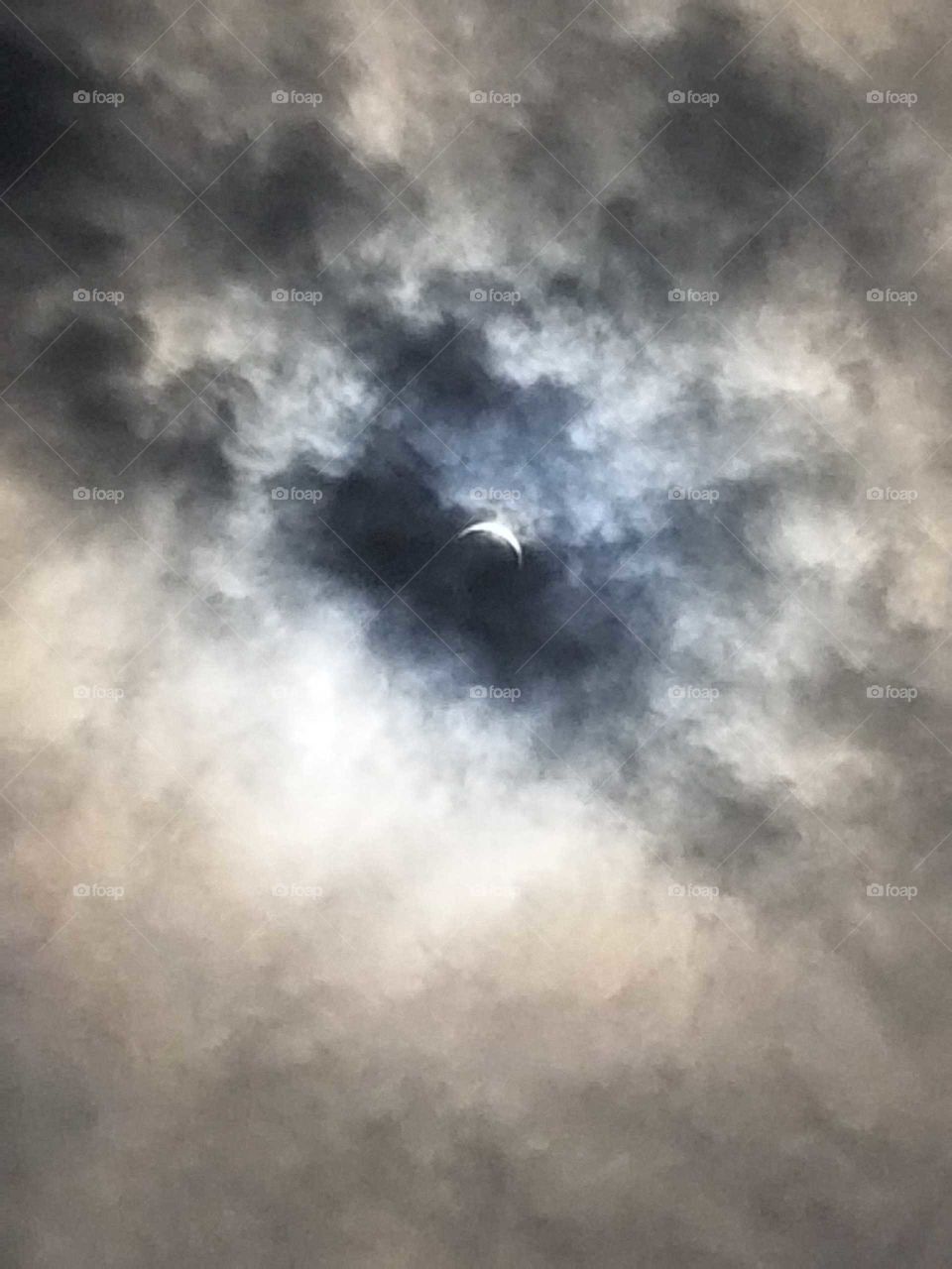 Amazing!! solar eclipse through the clouds.