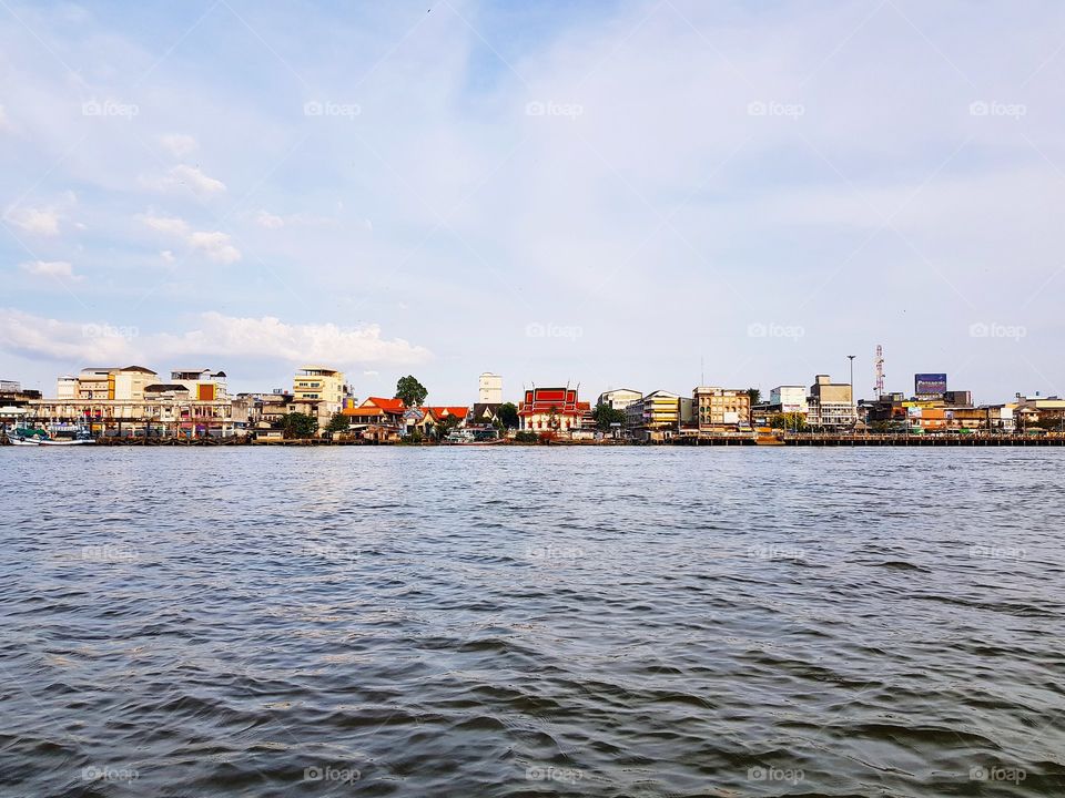 Scenic view of cityscape beside river