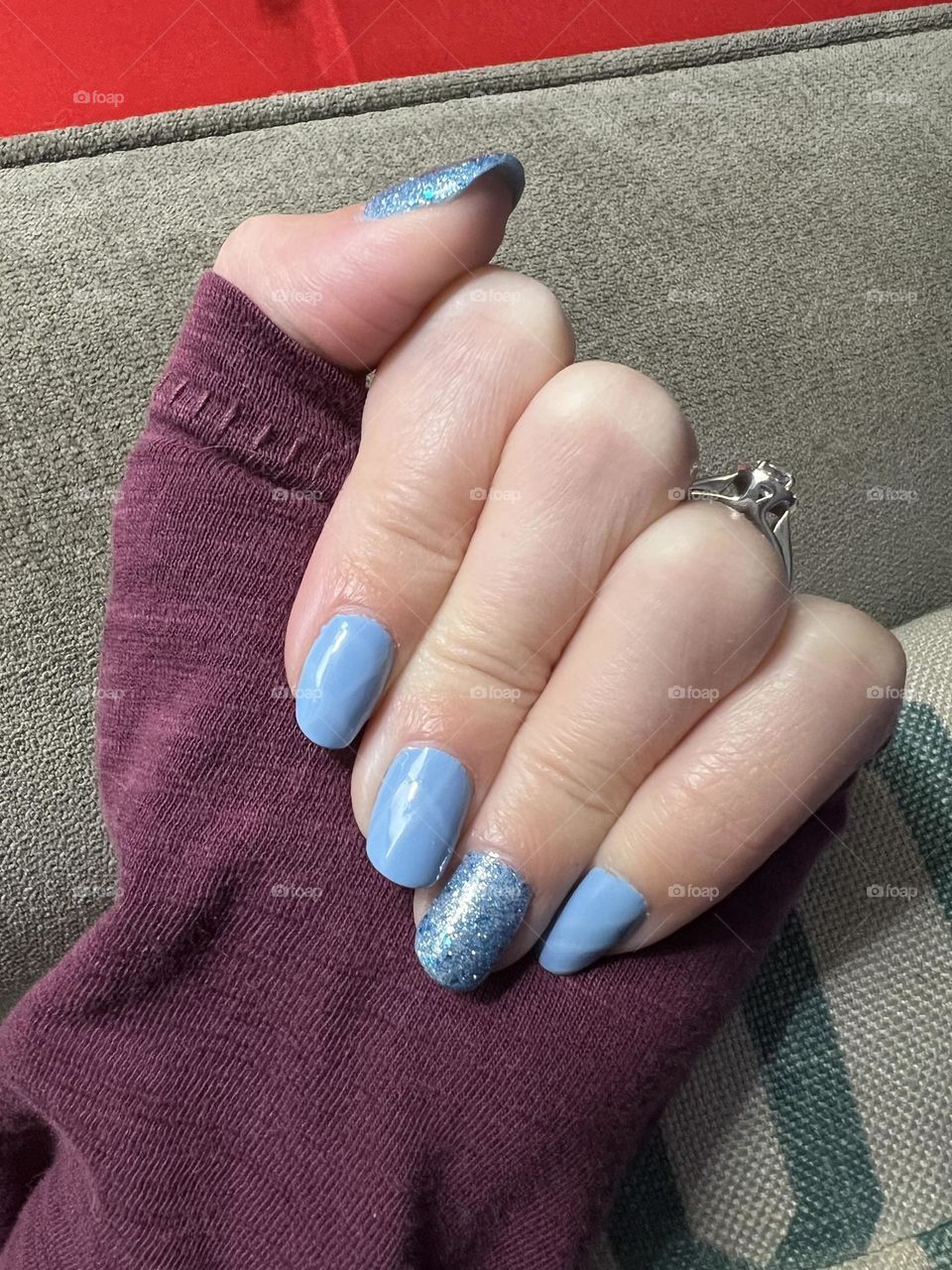 Soft blue and sparkly nail polish manicure 