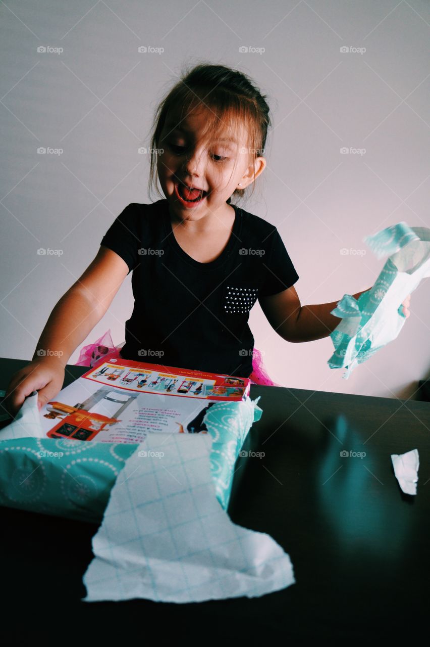 Little girl opening gift box