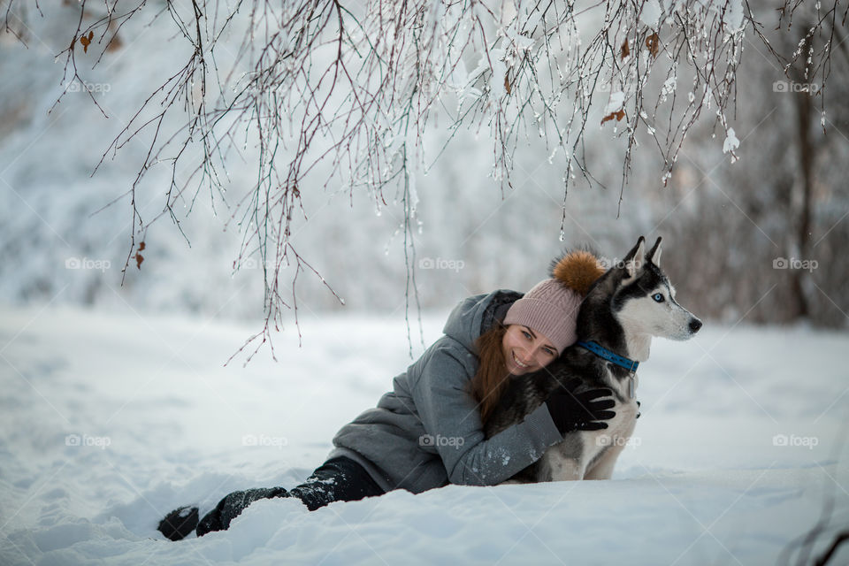 Walking with husky in winter park