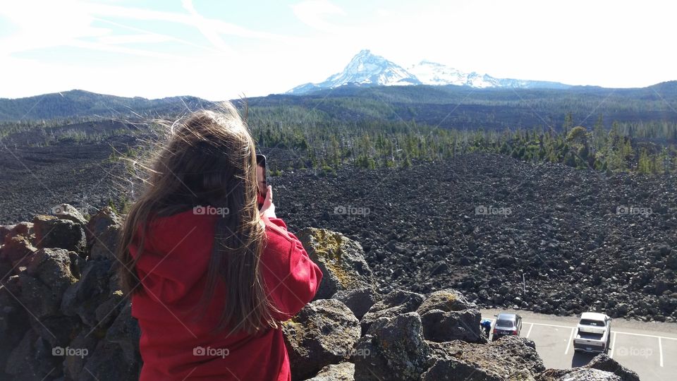 girl taking photo of mountain