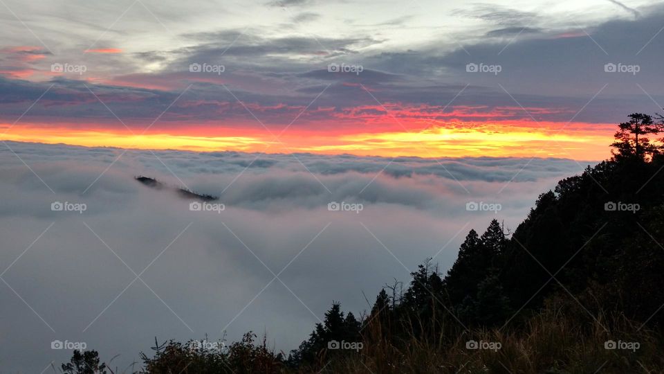 Sunrise above the clouds on a mountain