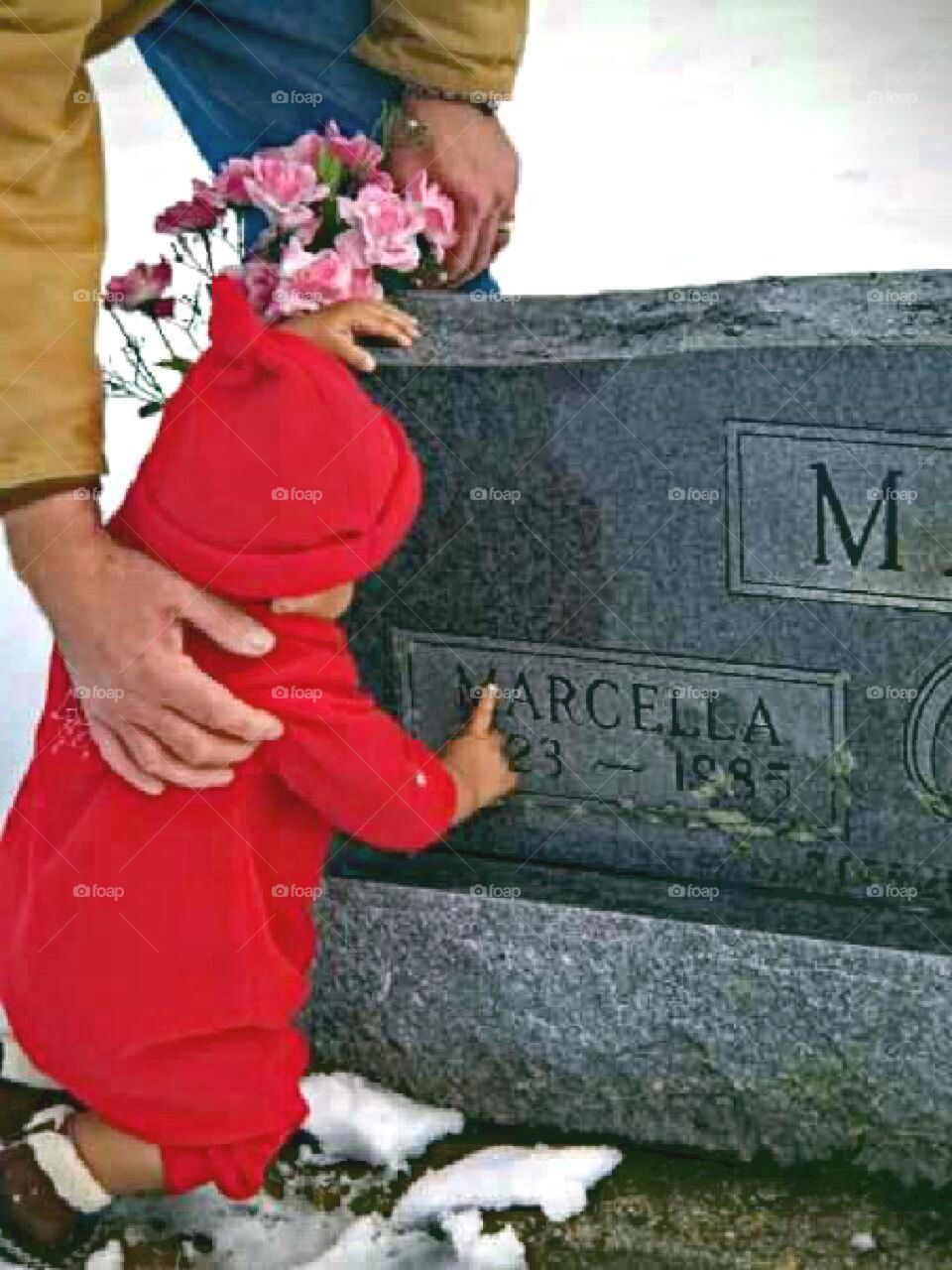 Child visiting cemetery with Father.