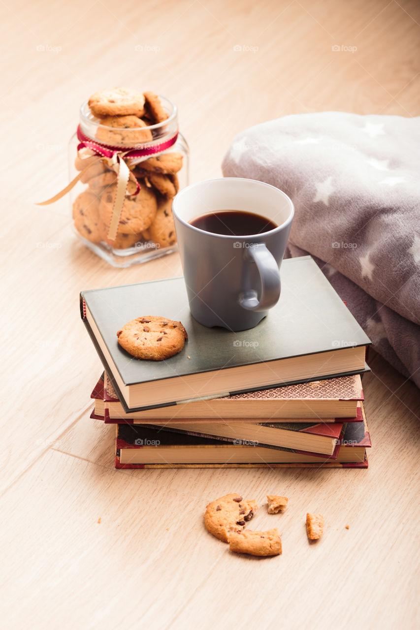 A few books with cup of coffee and cookies on wooden floor. Time for relax. Spending leisure time on reading. Cozy and comfortable. Relaxing π