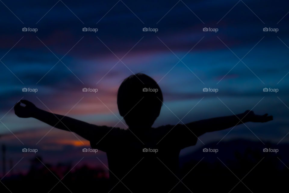 Portrait outdoor. silhouette of a kid on summer evening