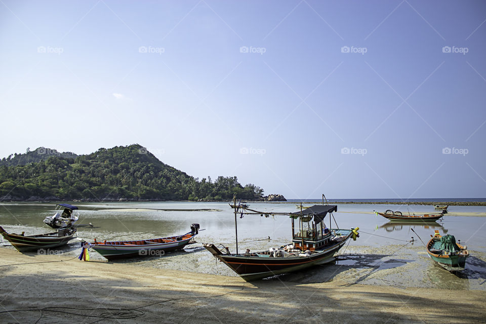 Fishing boats parked on the Beach at Koh Phangan, Surat Thani in Thailand.