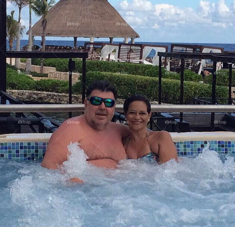 Couple in whirlpool in hotel in Cancun, Mexico.