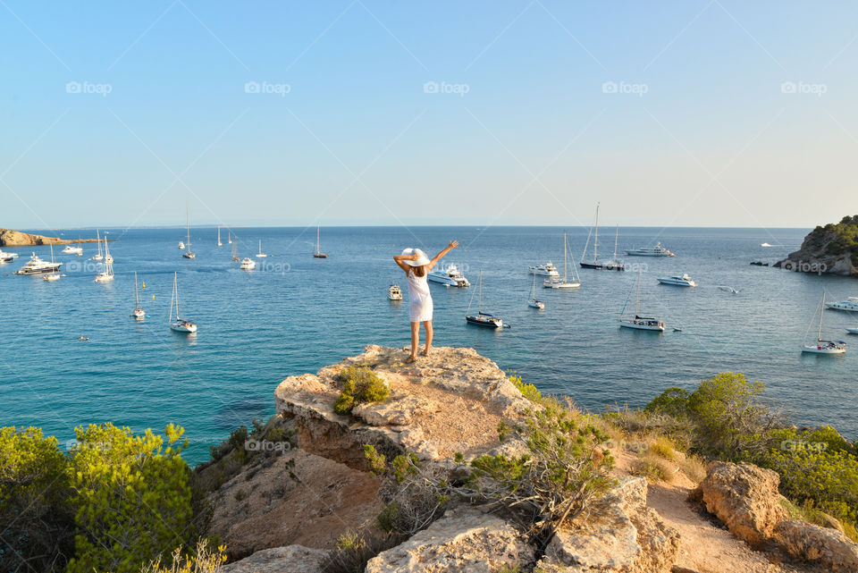 Girl looking at the sea from rocks