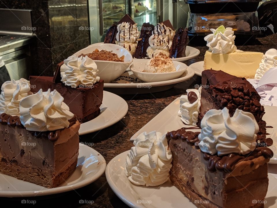 Gorgeous array of cheesecake and whipped cream.