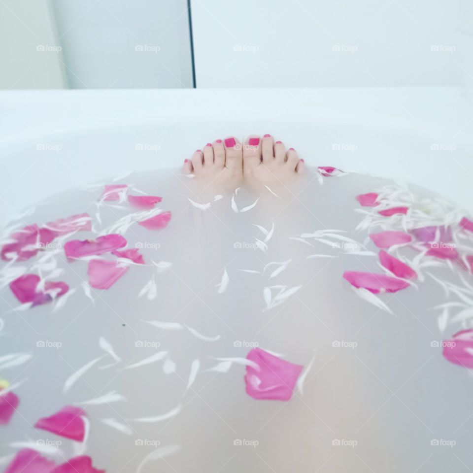 relaxing with pink rose petals in the bath