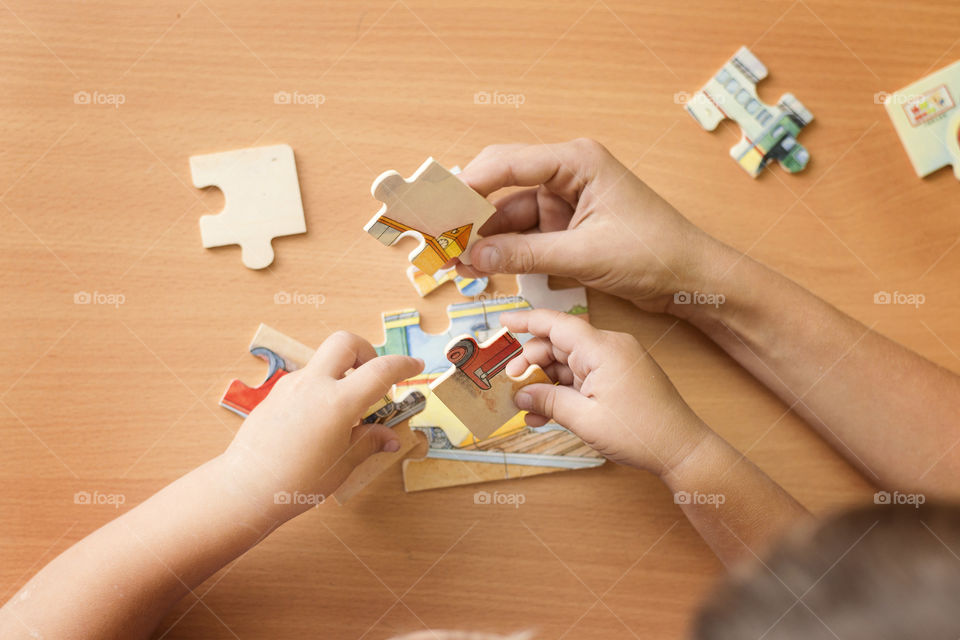 Boys holding puzzle pieces
