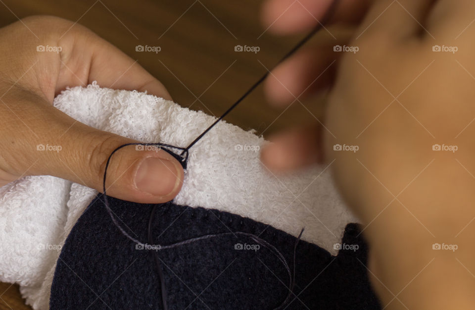 Sewing a towel with blue thread